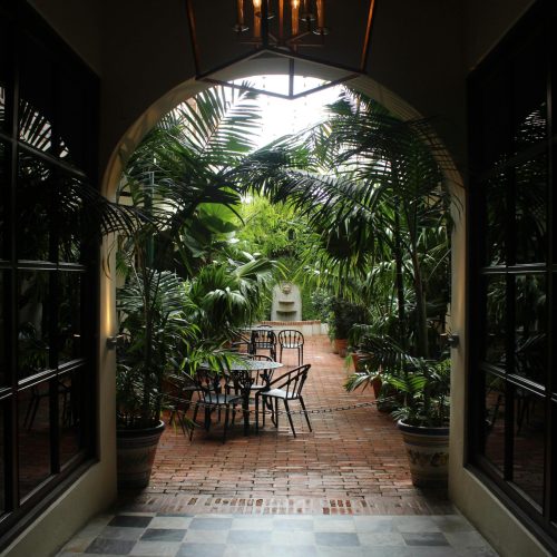 Serene outdoor patio surrounded by tropical plants in San Juan, Puerto Rico.